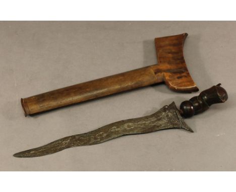 A MALAYAN KRIS of typical form with carved wooden handle and hardwood scabbard,  the bade 20.5cm  long CONDITION: Scabbard an