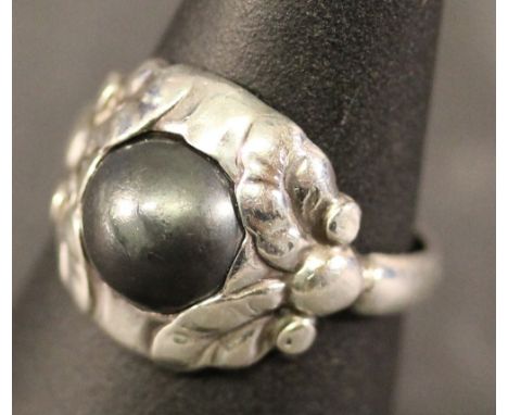 A GEORG JENSEN 830 GRADE HEMATITE-SET RING, the central circular cabochon set in moulded foliate surround, marked '830 Denmar