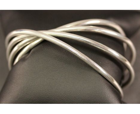 A GEORG JENSEN 'ALLIENCE' BANGLE formed as four fused tubular open bangles, a design by Allen Scharff, marked 925, with Georg