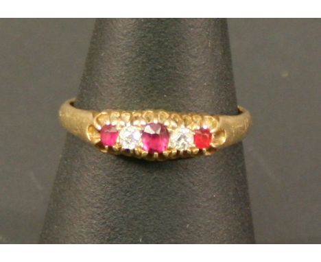 AN 18CT GOLD RUBY AND DIAMOND RING with three round-cut rubies interspersed by two conforming diamonds, marked 18, ring size 