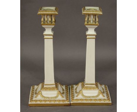 A PAIR OF VICTORIAN ROYAL WORCESTER CANDLESTICKS of Neo Classical column form with gilt embellishment, printed green mark to 