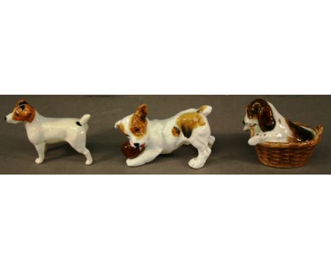 TWO ROYAL DOULTON PUPPY FIGURES one modelled in a basket, the other playing with a ball (2) together with a Beswick Jack Russ