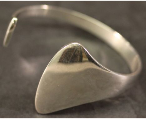A GEORG JENSEN 925S BANGLE of shaped and open circular form, sold with Georg Jensen box. 6.5cm, 44grams  CONDITION: Some fine