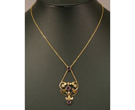 AN EDWARDIAN 9CT GOLD AMETHYST AND SEED PEARL NECKLACE the stylised foliate drop with inset seed pearls and amethysts, suspen