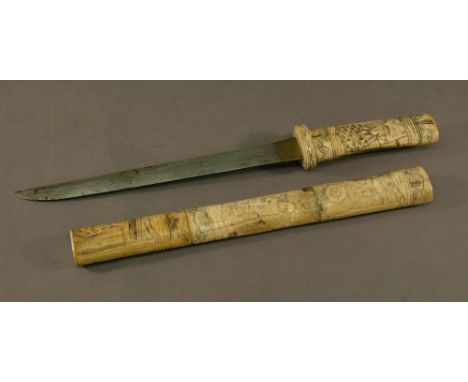 A JAPANESE CARVED BONE TANTO, carved throughout with various figures and scenes. 43cm(overall)  CONDITION: Age staining and s