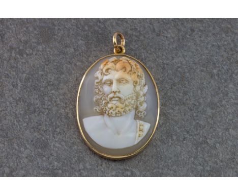 A shell cameo pendant, featuring a portrait of a bearded man in the Hellenistic style, within a 9ct gold surround, with 9ct g
