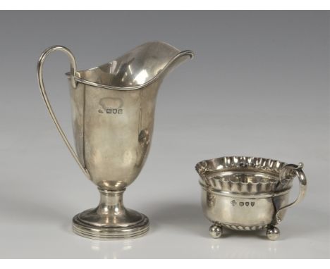 An Edwardian / George V silver helmet cream jug, maker's mark rubbed, London, 1910, of typical form, raised on circular base,