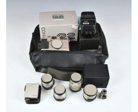 A Contax G2 Rangefinder Camera outfit, 1996, titanium, comprising a boxed camera body, serial no. 001953, with instructions; 