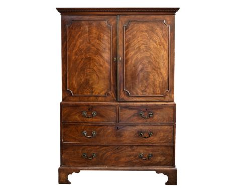 of small proportions, c.1780, the key carved cornice over a pair of well figured panelled doors enclosing the original slides