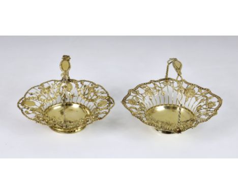 A matched pair of George III silver-gilt pierced baskets, maker's marks indistinct, London 1766 &amp; 1771, of shaped oval fo