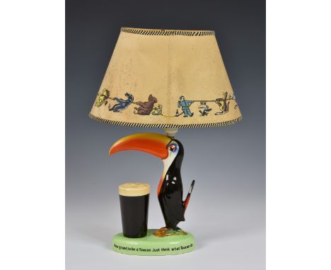 Advertising interest - A Carlton Ware Guinness Toucan table lamp, modelled with a toucan standing before a pint of Guinness, 