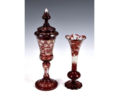 A late 19th century Bohemian ruby flashed and finely wheel cut glass covered goblet, decorated with roundels above hunting sc