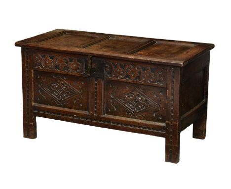 A late 17th century carved oak small coffer, the three panel top on original split pin hinges, enclosing an interior with can