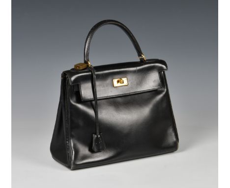 Hermes – a black leather Box Kelly Retourne 28 bag, purchased by vendor c.1977/78, with gold tone hardware, stamped ‘Hermes P