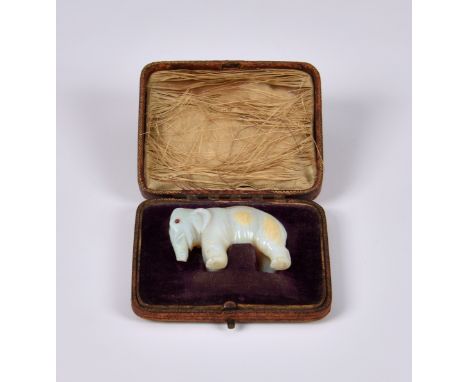 An carved white opal and ruby figure of an elephant, late 19th / early 20th century, probably Anglo-Indian, the eyes set with