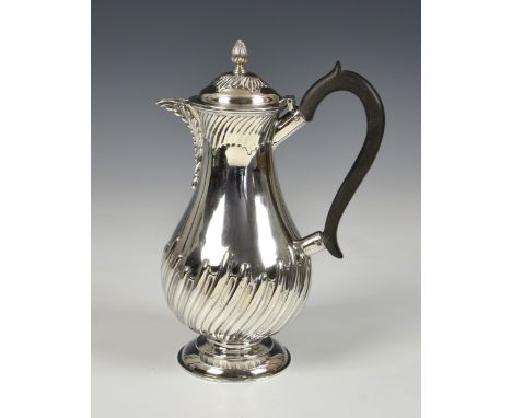 A Victorian silver baluster hot water jug, maker's mark rubbed, London, 1894, of typical form with part wrythan decoration, c