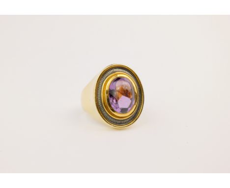 An 18ct gold, amethyst and enamel ring by Leo de Vroomen, the oval cabochon-cut amethyst within a grey guilloché enamel borde