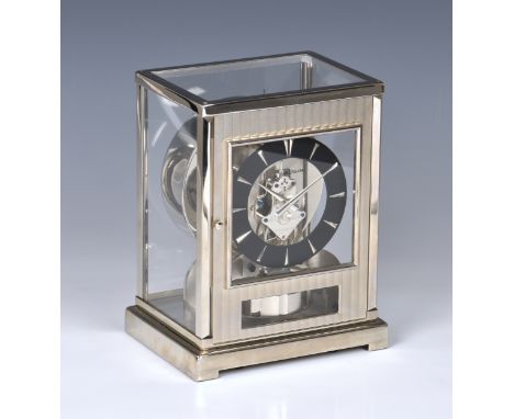 A Jaeger LeCoultre chrome and brushed stainless steel Atmos clock, believed 1970s, the front door with fluted, brushed steel 