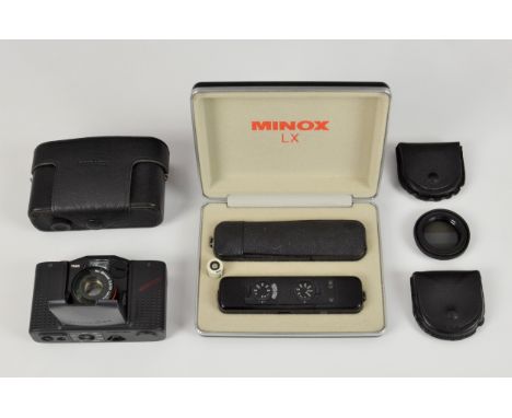 A Minox LX subminiature 'spy' camera, black, in the original case, with leather carrying case with chain; together with a Min