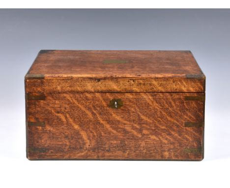 An early 20th century oak and brass bound box by Army &amp; Navy Stores, possibly a campaign work box, 14 x 18in. (35.5 x 45.