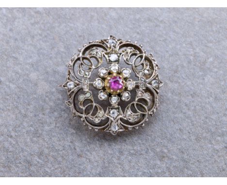 A Victorian ruby and rose cut diamond brooch, the openwork brooch of foliate design, set to the centre with a cushion-cut rub