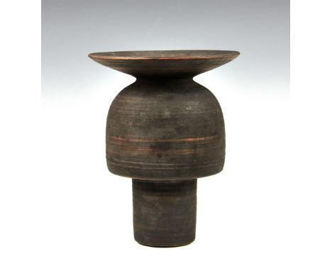 A stoneware studio pottery vase in the manner of Hans Coper, 1970s, with disc rim over an inverted cup form body and slender,