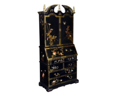 A Chinese black lacquered and painted George II style bureau cabinet, third quarter 20th century, the broken arched top with 