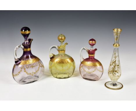 A graduated set of three Bohemian glass flagons, late 19th century, having graduated tinted pink and purple enamel decoration