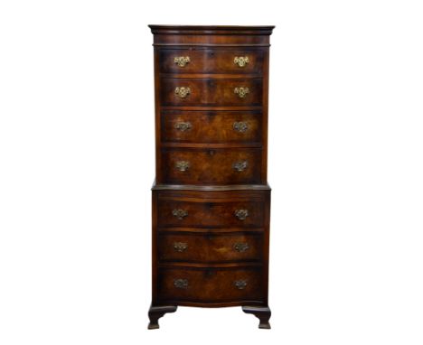 A Georgian style cross banded burr walnut serpentine tallboy chest, 1930s, the moulded cornice over an upper section with fou