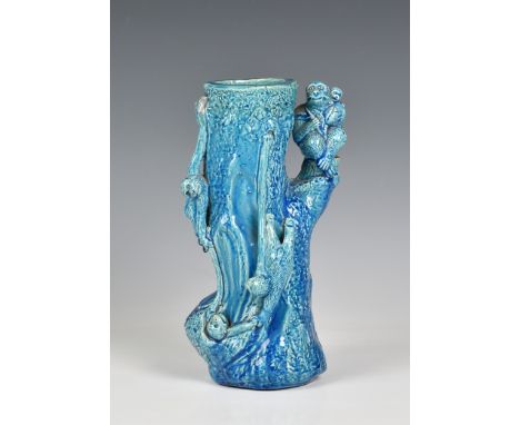 A Majolica turquoise glazed macaques vase, late 19th / early 20th century, the Orientalist vase modelled as the trunk of a tr