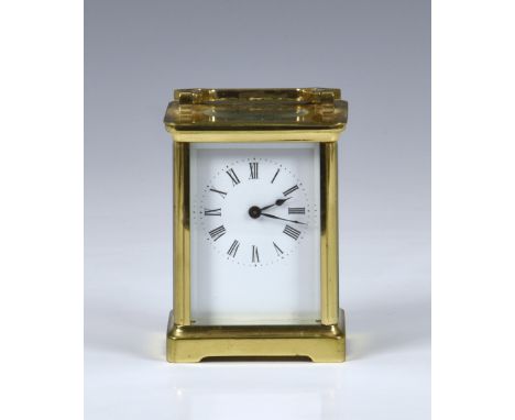 A late 19th century French brass carriage clock with leather travel case, the white enamel dial with Roman numerals and spade