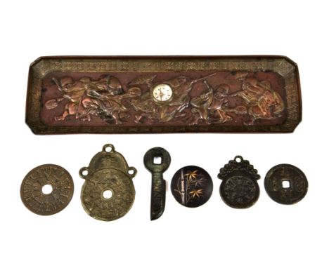 A Japanese metalwork Feng Shui tray with raised figures of minstrels, of rectangular form, centrally set with a compass, 9¾in