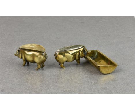 Two Edwardian novelty brass pigs - smoking related, probably French, the first fashioned standing at a trough, his back with 