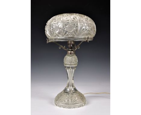 An early 20th century cut glass table lamp, with mushroom shaped shade on domed and waisted base, plated mounts, 19 ½in. (49.