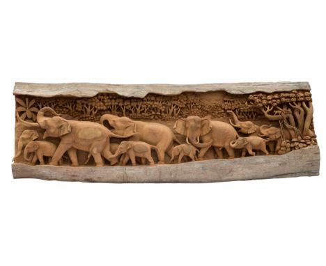 An Indian carved wooden elephant plaque, second half 20th century, the naturalistic split trunk deeply carved with a processi