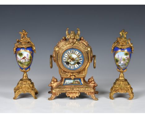 A French gilt metal and porcelain matched three piece clock garniture, early 20th century, in the baroque style, the J. Marti