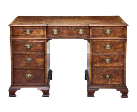 A Georgian style burr walnut inverted bowfront double pedestal desk, 1920s-30s, the moulded, cross banded top with inset leat