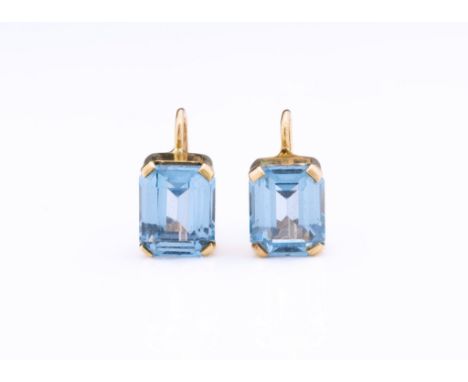 A pair of 9ct gold and blue spinel earrings, each set with a step-cut spinel measuring approx. 10 x 8mm. and with screw backs