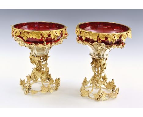 A pair of silver plated gilt table centrepieces with ruby red glass bowls, second half 20th century, the cast metal body with