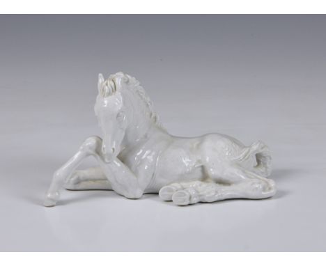 A Meissen porcelain blanc-de-chine model of a seated foal, 20th century, glazed in the white, underglaze blue crossed swords 