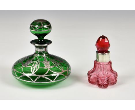 An Art Nouveau green glass silver overlay scent / perfume bottle, of squat globular form, the overlay having stylised floral 