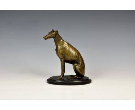 A 19th century French bronze seated Greyhound letter holder, with an articulated jaw, light to mid-brown patination, on an ov