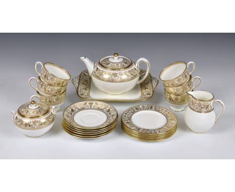A Wedgwood China 'Gold Florentine' pattern tea service, comprising of teapot, six cups &amp; saucers, cake plate, milk jug, c