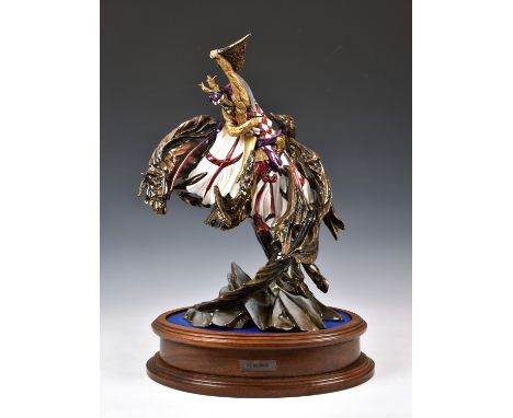 A Michael Sutty limited edition porcelain figure of St George, sword raised on his rearing horse, on a rocky outcrop, limited