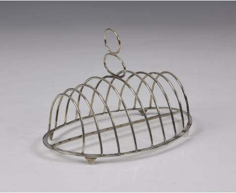 A George III silver toast rack, John Lambe, London, 1786, of oval form, nine plain wire-work bars, double central ring handle