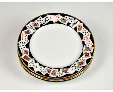 A boxed set of four Tiffany &amp; Co dessert plates, each with playing card motifs to borders on black ground with gilt rim, 