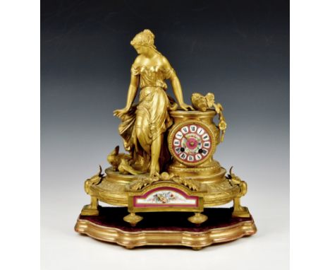 A French gilt metal and porcelain mantel clock, emblematic of Innocence, late 19th / early 20th century, with bell strike mov