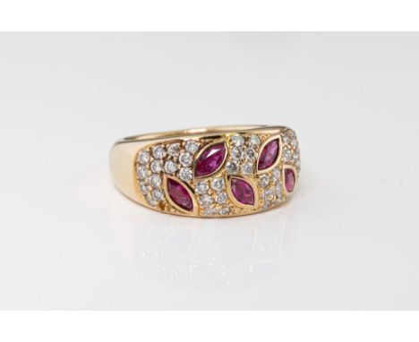 An 18ct yellow gold, ruby and diamond ring, the domed ring with five rub-over set marquise cut rubies within a border of pavé