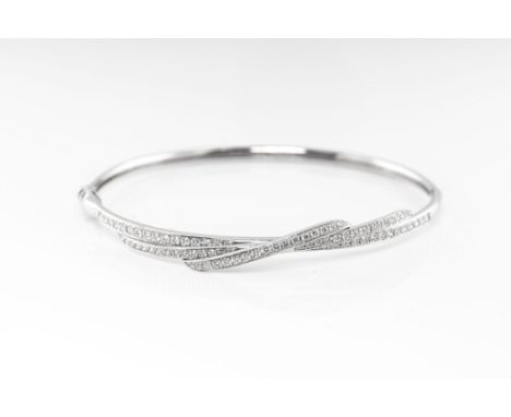 An 18ct white gold and diamond hinged bangle by Mappin &amp; Webb, the bangle with a three row cross over setting set with br