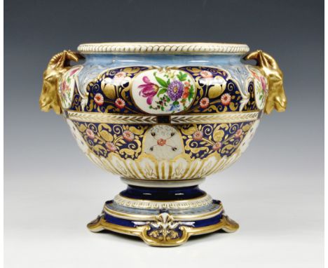 A Victorian ceramic jardinière, of shaped pedestal form, having twin goat head handles and floral decorated panels, gilt high